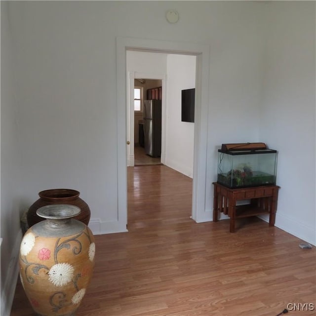 hallway with baseboards and light wood-type flooring