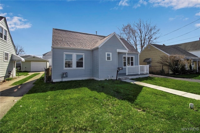 bungalow-style home featuring a garage, a shingled roof, a front lawn, and an outbuilding