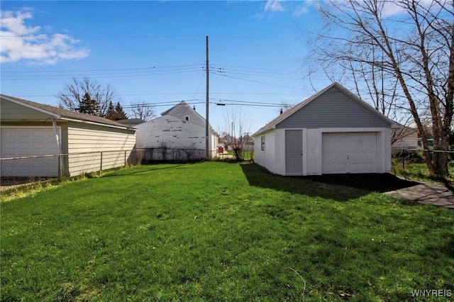 view of yard with fence and an outdoor structure