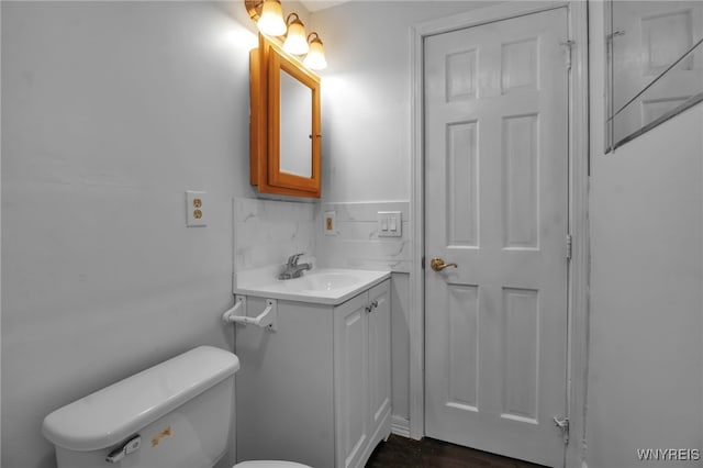bathroom with toilet and vanity