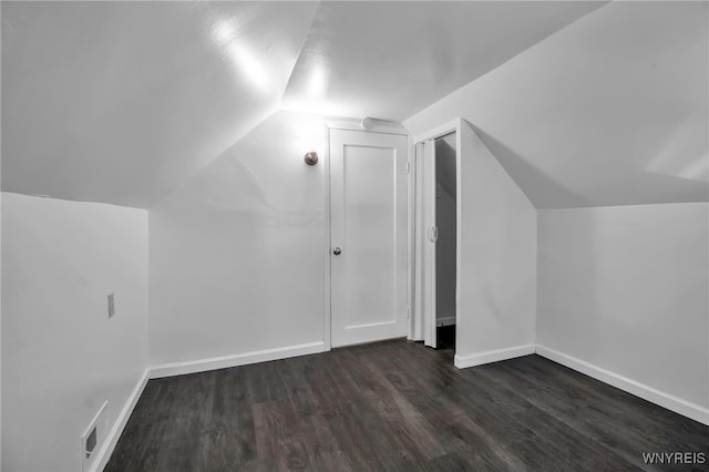 bonus room featuring wood finished floors, lofted ceiling, and baseboards