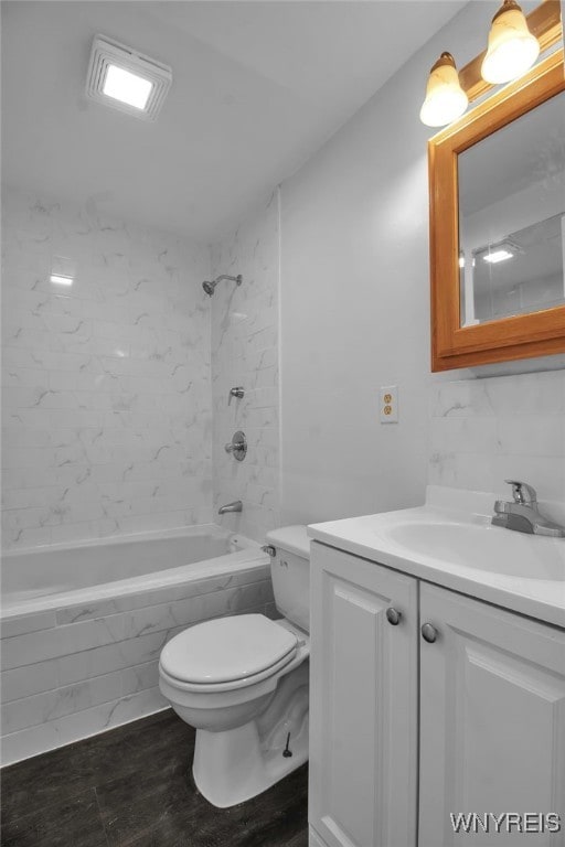 bathroom with toilet, shower / tub combination, and vanity