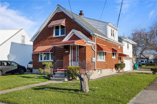 view of front of property featuring a front yard, a chimney, an attached garage, and brick siding
