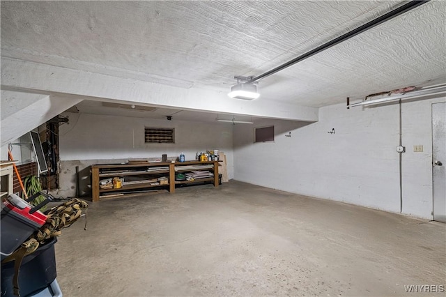 garage featuring a garage door opener and a workshop area