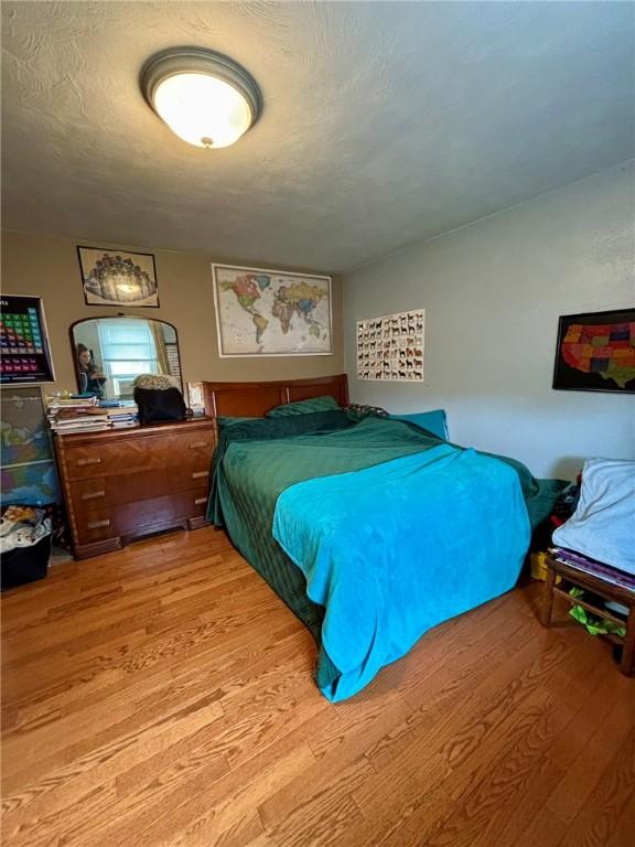 bedroom with wood finished floors
