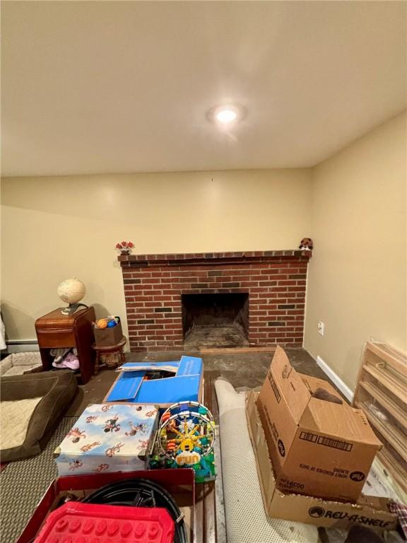living room with baseboards, carpet floors, and a fireplace