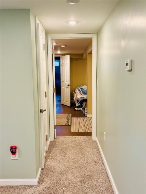 corridor featuring carpet flooring and baseboards