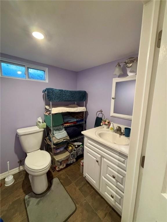 half bathroom featuring toilet and vanity