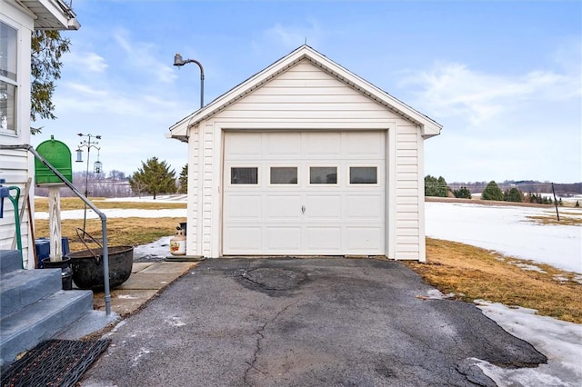 detached garage featuring aphalt driveway