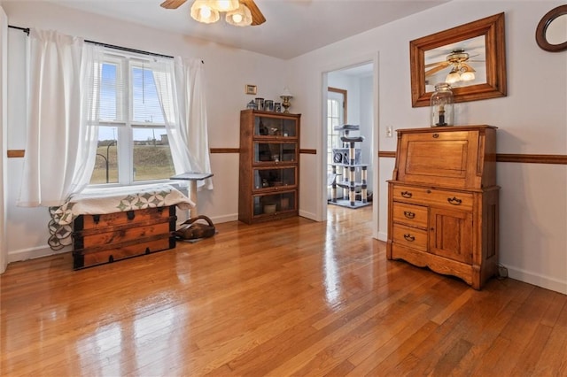 2481 County Road 20, Phelps, NY 14432 - living area with a ceiling fan, light wood-style floors, and baseboards