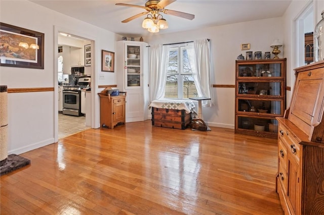 2481 County Road 20, Phelps, NY 14432 - dining space featuring light wood-type flooring, ceiling fan, and baseboards