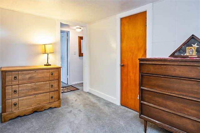 bedroom featuring carpet and baseboards