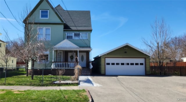view of front of home with a garage, fence private yard, covered porch, and an outbuilding
