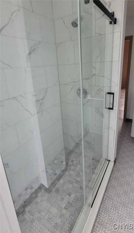 full bathroom featuring tile patterned floors and a stall shower