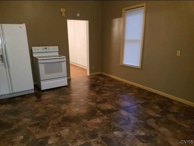 kitchen featuring baseboards, dark floors, and white appliances