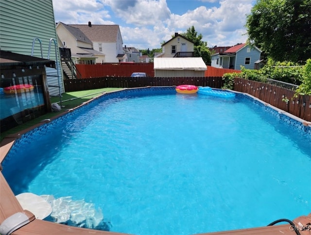 view of swimming pool with a residential view, a fenced in pool, and a fenced backyard