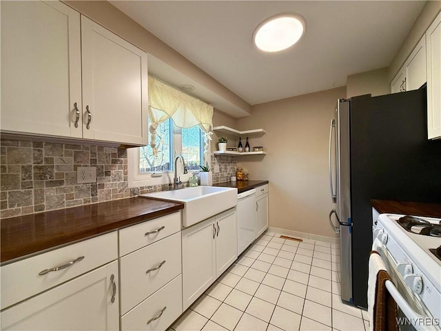 kitchen featuring tasteful backsplash, white appliances, white cabinets, and a sink