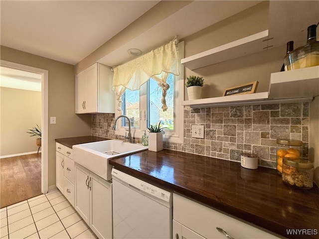 kitchen with tasteful backsplash, open shelves, white cabinets, a sink, and dishwasher