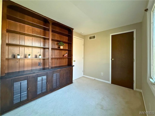 carpeted empty room with baseboards and visible vents