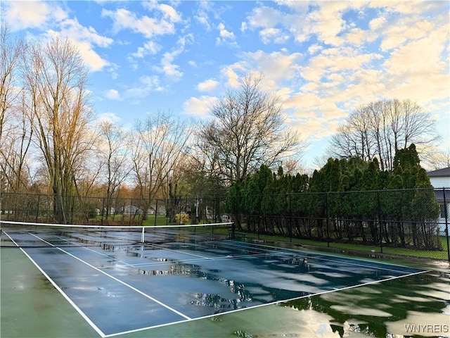 view of tennis court featuring fence