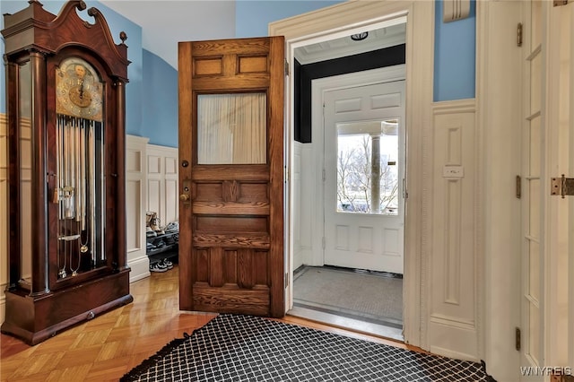foyer featuring a wainscoted wall and a decorative wall
