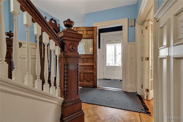 interior space featuring a wainscoted wall and stairs