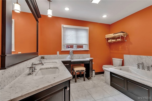 bathroom featuring toilet, tile patterned flooring, double vanity, and a sink