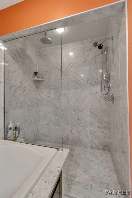full bath featuring tiled shower