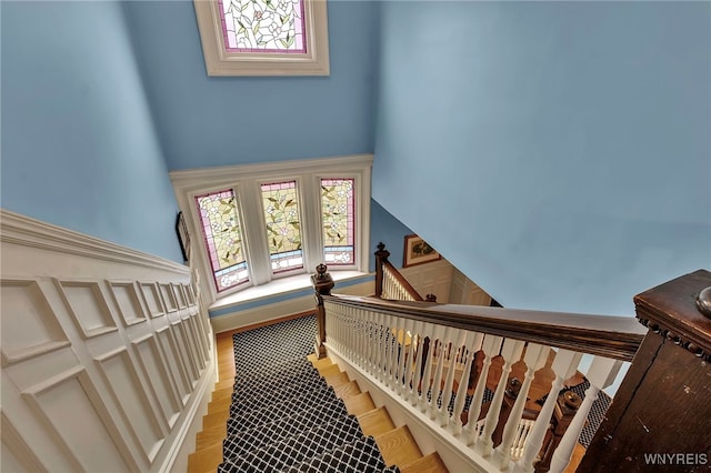 stairway featuring wood finished floors and baseboards