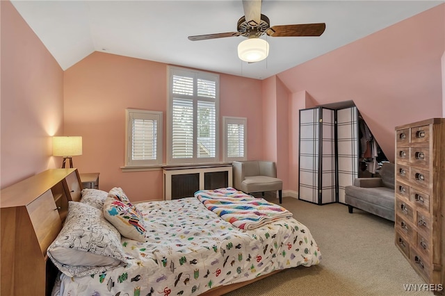 carpeted bedroom featuring a ceiling fan and vaulted ceiling
