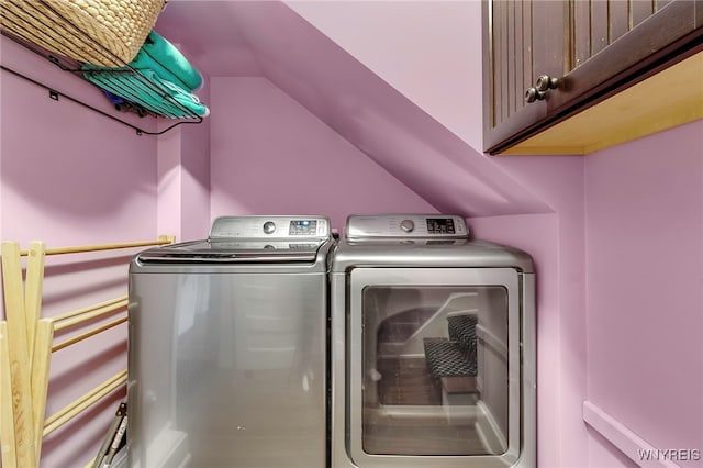 laundry area featuring independent washer and dryer and cabinet space