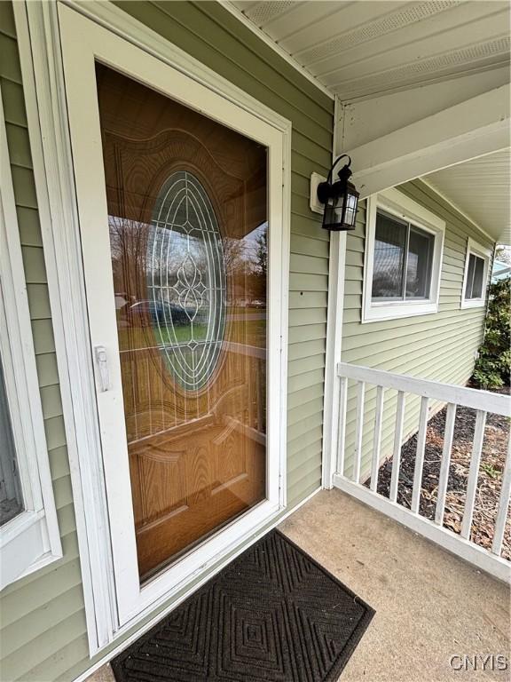 doorway to property featuring covered porch