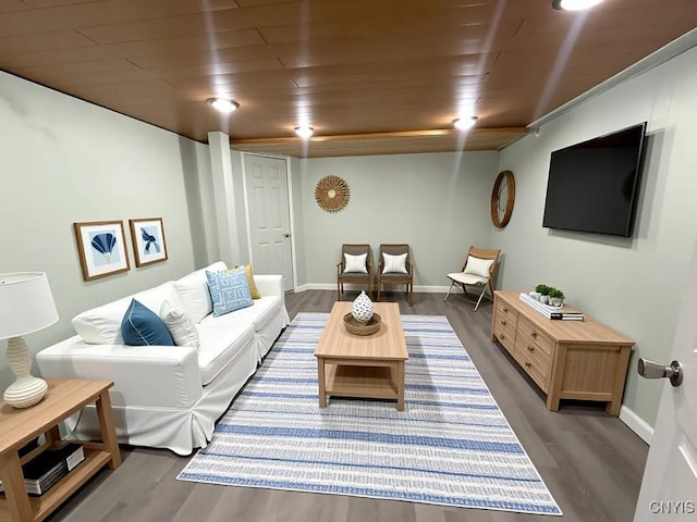 living room featuring wood ceiling, wood finished floors, and baseboards