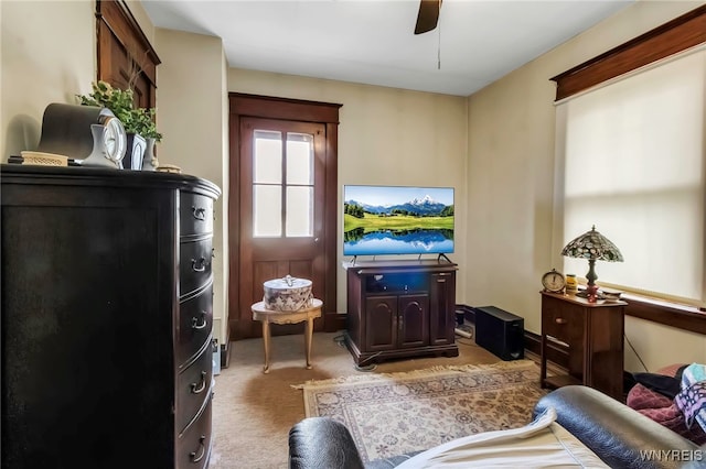 interior space featuring ceiling fan and light carpet