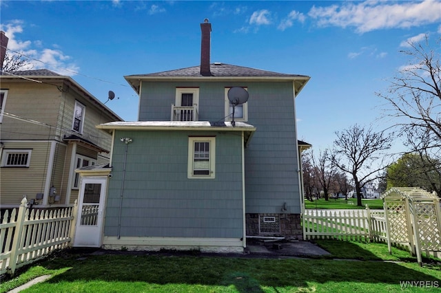 rear view of house featuring a yard and fence private yard