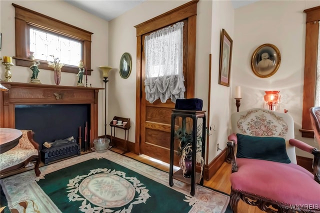 sitting room with wood finished floors and baseboards