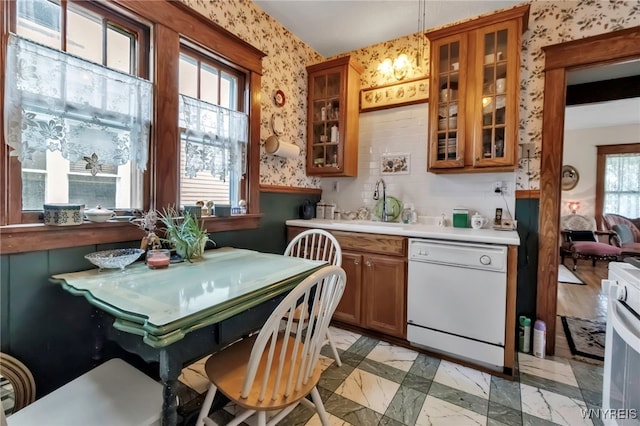 kitchen with wallpapered walls, white appliances, light countertops, and brown cabinets