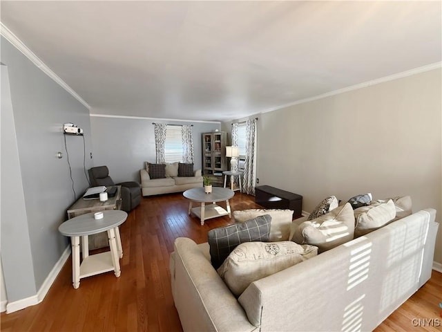 living area featuring hardwood / wood-style flooring, crown molding, and baseboards