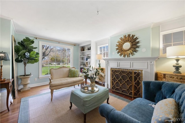 422 Salt Springs Rd, Manlius, NY 13066 - living room featuring wood finished floors, a tiled fireplace, crown molding, and built in features