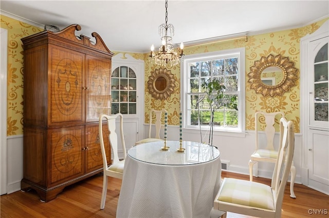 422 Salt Springs Rd, Manlius, NY 13066 - dining space featuring wood finished floors, a chandelier, ornamental molding, and wallpapered walls