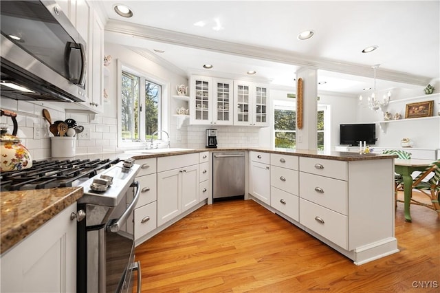 422 Salt Springs Rd, Manlius, NY 13066 - kitchen with appliances with stainless steel finishes, white cabinets, a sink, a peninsula, and crown molding