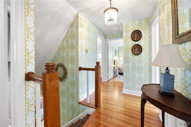 422 Salt Springs Rd, Manlius, NY 13066 - corridor with an upstairs landing, wood finished floors, wallpapered walls, and baseboards