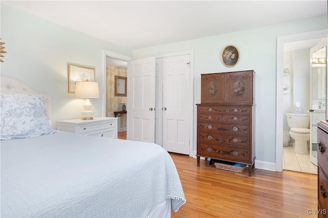 422 Salt Springs Rd, Manlius, NY 13066 - bedroom with a closet, baseboards, connected bathroom, and light wood-type flooring
