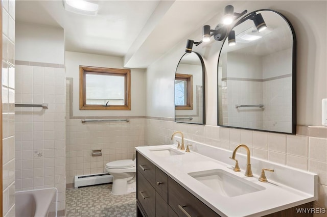 1631 Tuscarora Rd, Niagara, NY 14304 - bathroom featuring a baseboard heating unit, tile walls, a sink, and toilet
