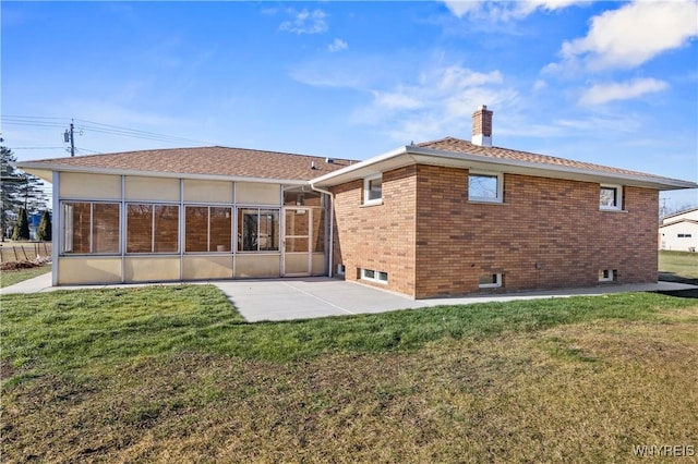 1631 Tuscarora Rd, Niagara, NY 14304 - rear view of house featuring a lawn, a chimney, a patio, and a sunroom
