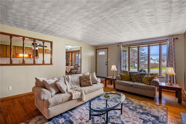 1631 Tuscarora Rd, Niagara, NY 14304 - living area featuring a textured ceiling, wood finished floors, and baseboards