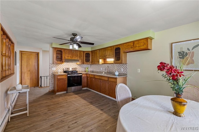 1631 Tuscarora Rd, Niagara, NY 14304 - kitchen featuring electric stove, brown cabinets, under cabinet range hood, and a sink