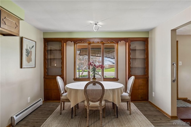 1631 Tuscarora Rd, Niagara, NY 14304 - dining space featuring a baseboard heating unit, wood finished floors, and baseboards
