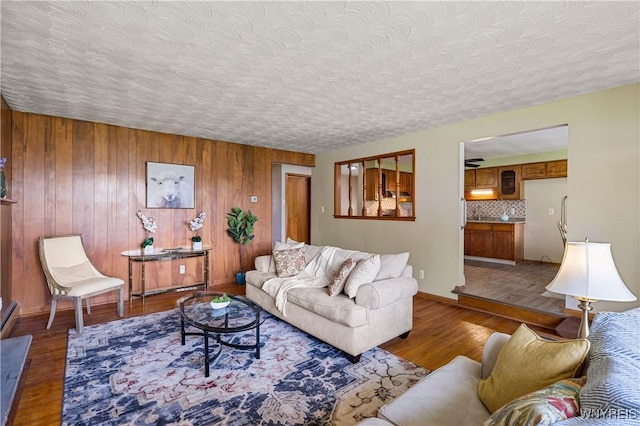 1631 Tuscarora Rd, Niagara, NY 14304 - living area with wood walls, a textured ceiling, wood finished floors, and baseboards