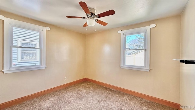 unfurnished room with baseboards, ceiling fan, and carpet flooring